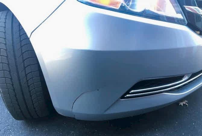 Close-up of a repaired bumper crack with a smooth finish