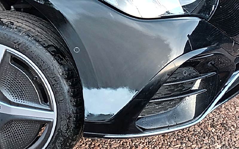 Close-up of bumper scratch repair process